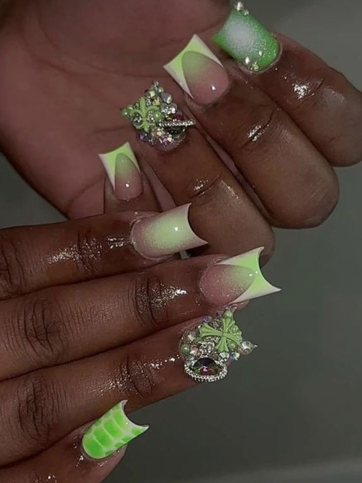 Vibrant Gradient French Tip Nail Design with Luxurious Gem Embellishments.