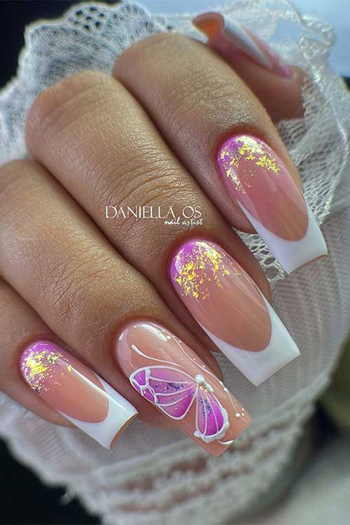 Chic Nude and White Nail Design with Vibrant Butterfly Accents and Glamorous Gold Flakes.