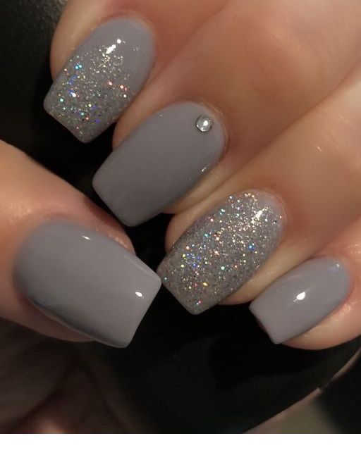 Elegant Matte and Glittery Nail Design with Soft Gray Base and Colorful Shimmer Accents.