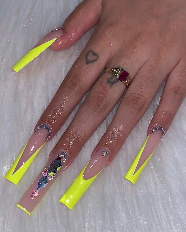 Bold Neon Yellow Nails with Geometric Cutouts and Colorful Gemstones for a Glamorous Statement.