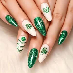 Festive Stiletto Nail Design: Vibrant Green and White with Sparkly Motifs.