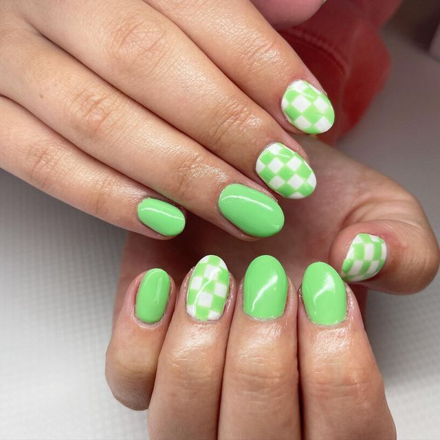 Playful Vibrant Green Nail Design: A Fresh Mix of Solid and Checkered Patterns.