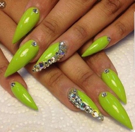 Bold Neon Green Stiletto Nails with Sparkling Rhinestone Accents.