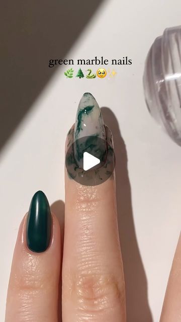 Elegant Green Marble Nail Design with Bold Pointed Shape and Contrast