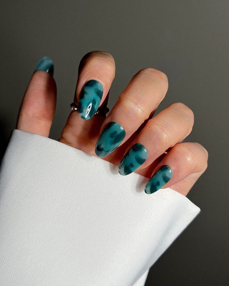 Elegant Teal Marble Nail Design: A Stunning Contrast for Sophisticated Manicures.