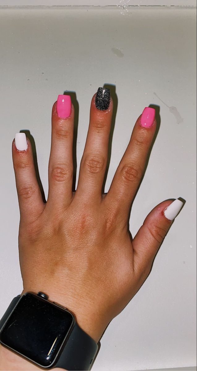 Chic Colorful Nail Design: Bold Pink, Crisp White, and Striking Black Glitter Accents.