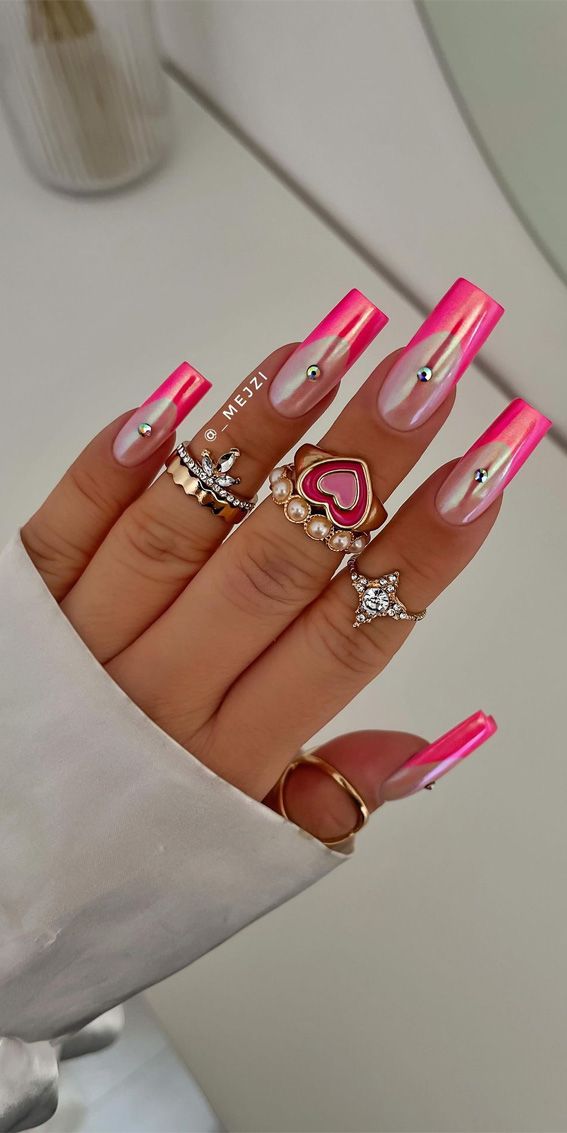 Vibrant Pink Ombre Nail Design: A Trendy Fusion of Playfulness and Elegance with Glamorous Details.