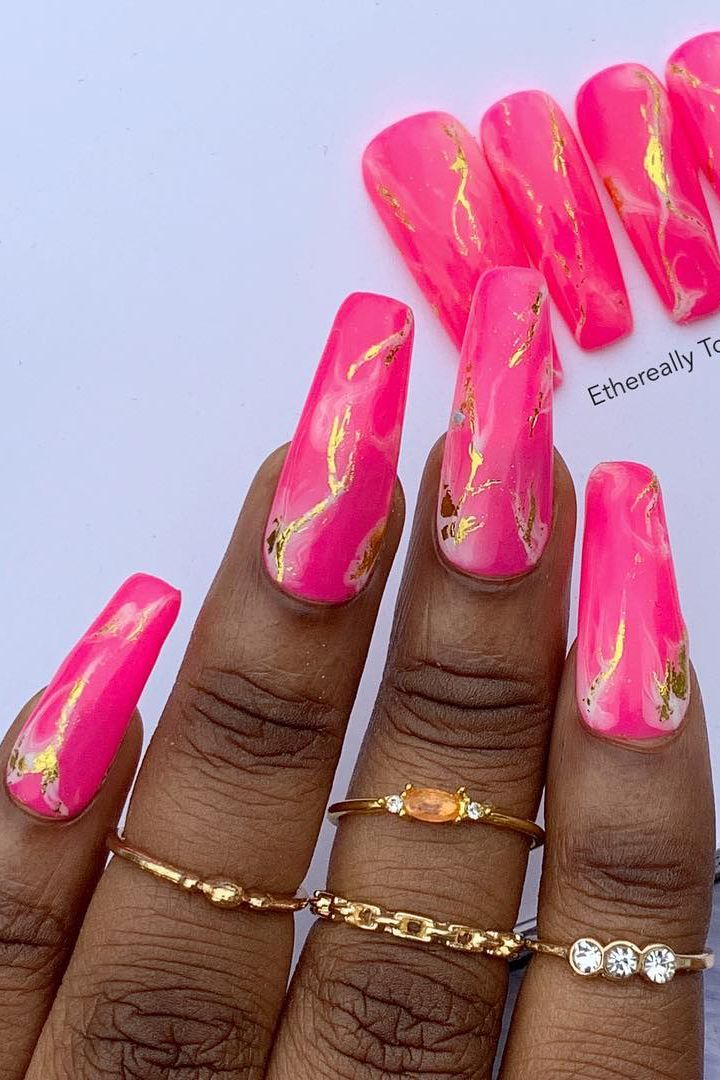 Glamorous Bold Pink Nails with Gold Foil Accents: A Playful yet Sophisticated Look.