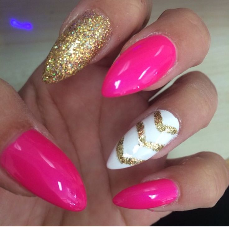 Playful Pink and Glittering Gold Almond-Shaped Nail Design with Chevron Elegance.