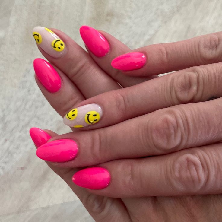 Playful Hot Pink Nail Design with Cheerful Yellow Smiley Faces.