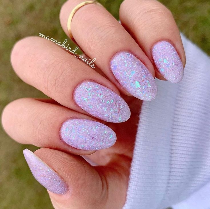 Elegant Pastel Pink Nail Design with Iridescent Flakes and Oval Shape