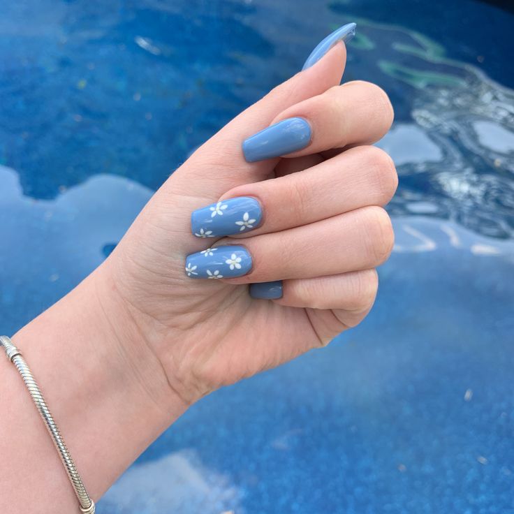 Chic Summer Elegance: Blue Nails with Delicate White Floral Designs