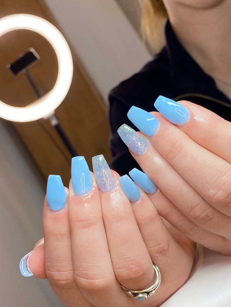 Playful Blue Nail Design with Glossy Square Tips and Iridescent Glitter Accents.