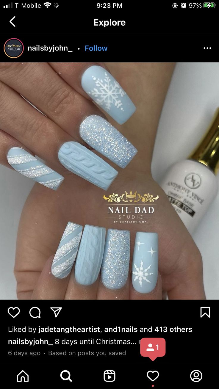 Cozy Winter Nail Design: Soft Blue with Snowflakes and Glitter Accents