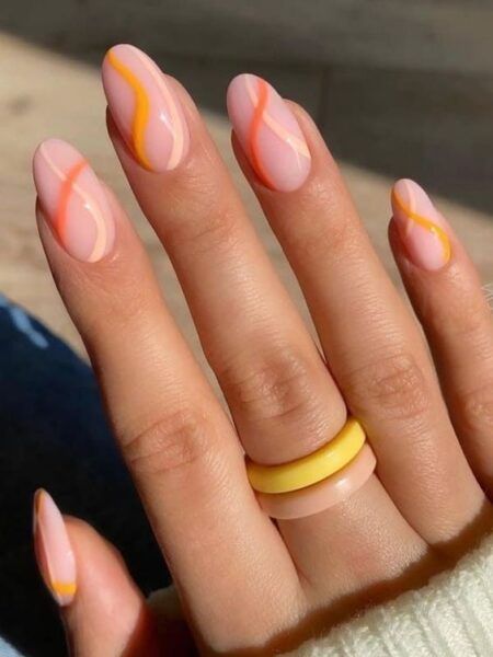 Chic Soft Pink Nail Design with Wavy Orange and Pastel Accents.