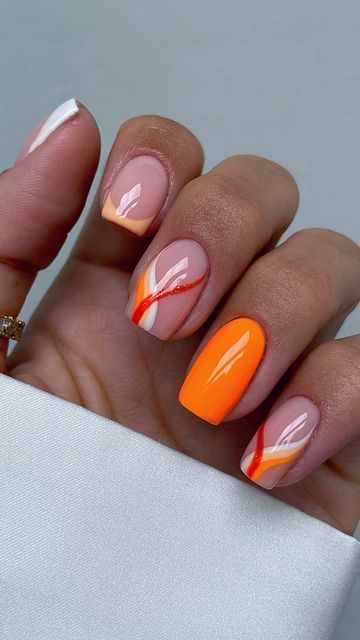 Vibrant Orange Nail Design with Geometric Patterns and Elegant Finishes