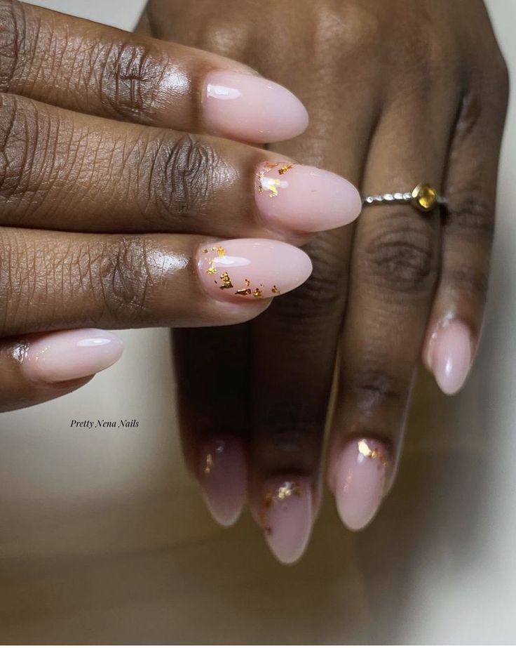 Elegant Almond-Shaped Nails with Nude Pink Polish and Glamorous Gold Flakes