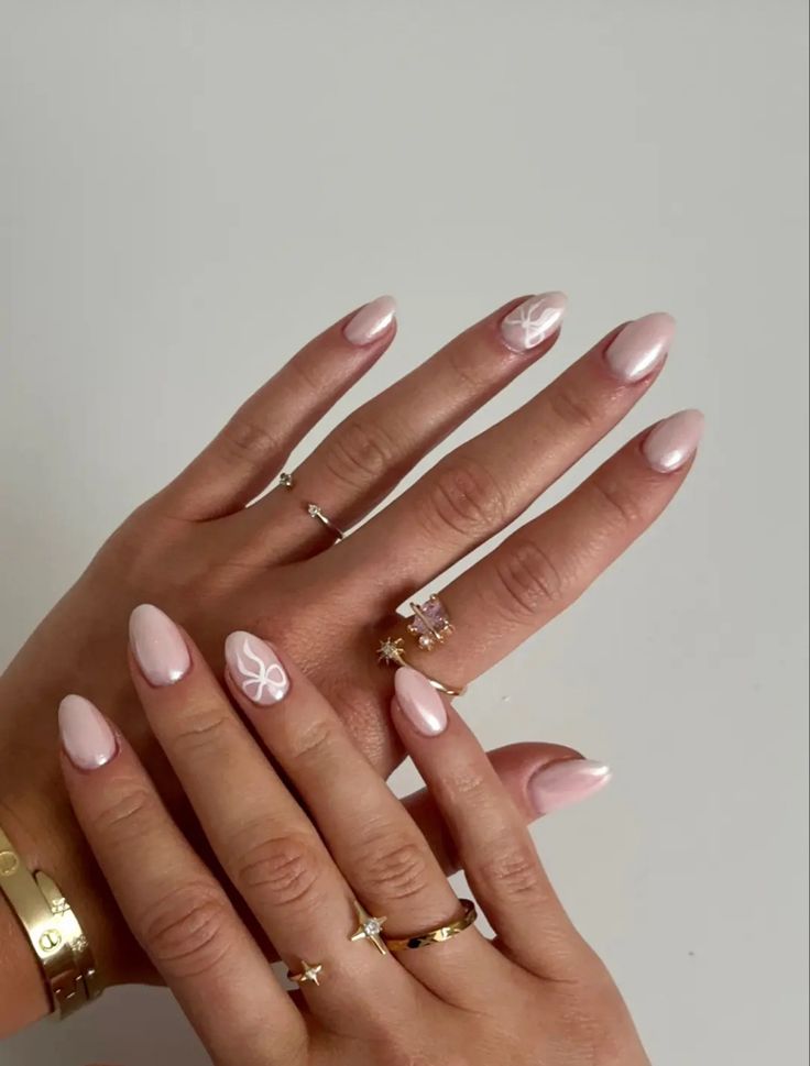 Chic Almond-Shaped Nail Design with Soft Pink Base and Whimsical Floral Accents.