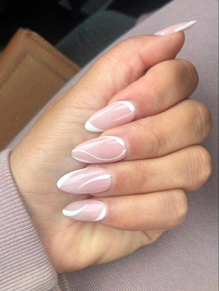 Chic Soft Pink Almond Nail Design with Elegant White Accents