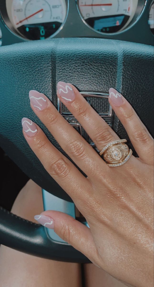 Chic Soft Pink Nail Design with Wavy Accents and Glamorous Rings for a Fashion-Forward Statement.