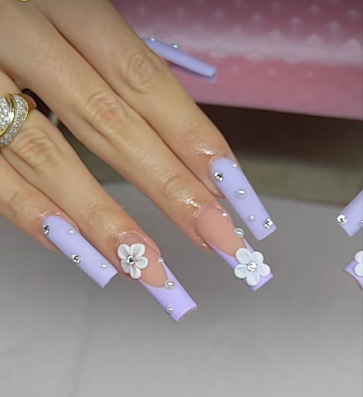 Chic Lavender Ombre Nails with Floral Accents and Rhinestones for a Whimsical Spring Look