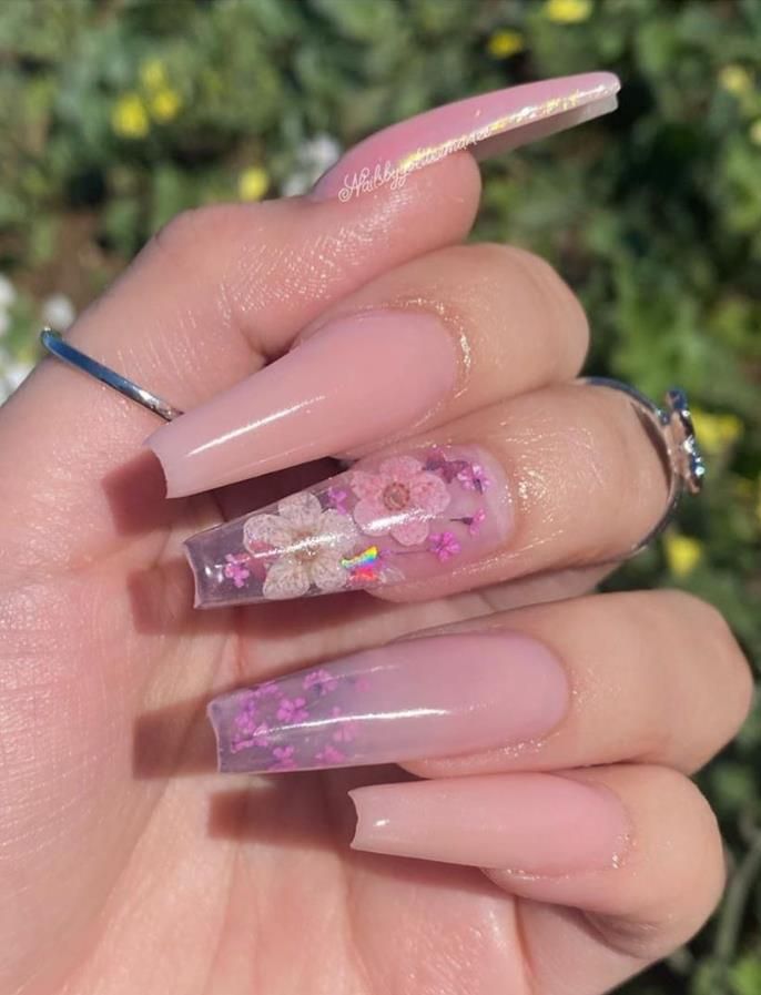 Chic Floral Nail Design: Nude Base with Intricate Embellishments and Elegant Transparency.