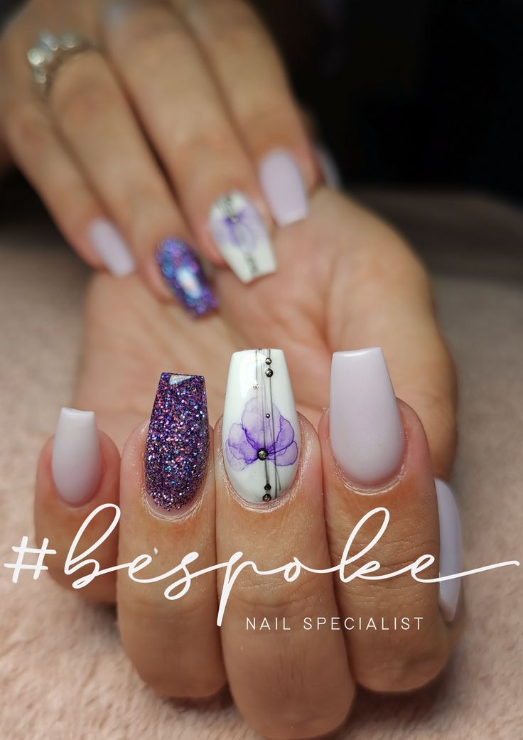 Elegant Pastel and Vibrant Nail Design with Sparkly Accents and Floral Artwork.