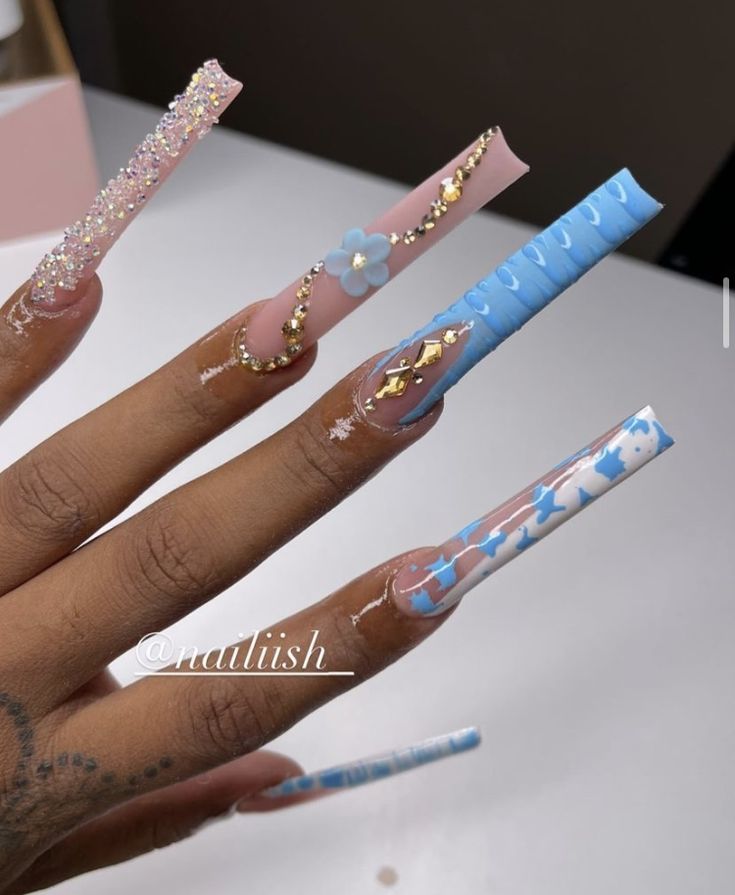 Pastel Pink and Blue Nail Design: Intricate Patterns with Glitter, Floral Accents, and Elegant Gold Details.