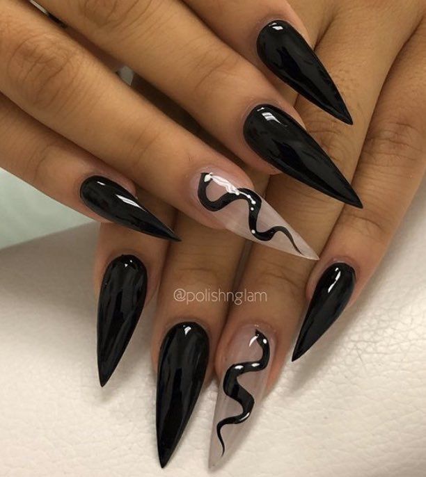 Bold Black Stiletto Nails with Elegant Nude Swirl: A Modern Nail Art Statement.