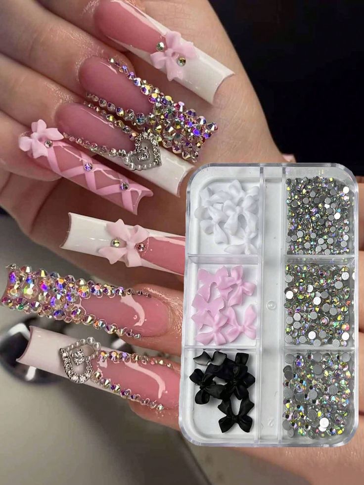 Vibrant Pink and White Acrylic Nails with Playful Embellishments for a Glamorous Look.