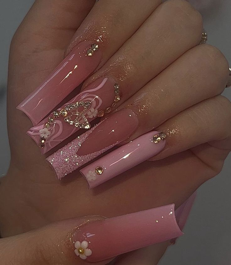 Luxurious Long Pink Nails with Intricate Designs and Elegant Finishes.