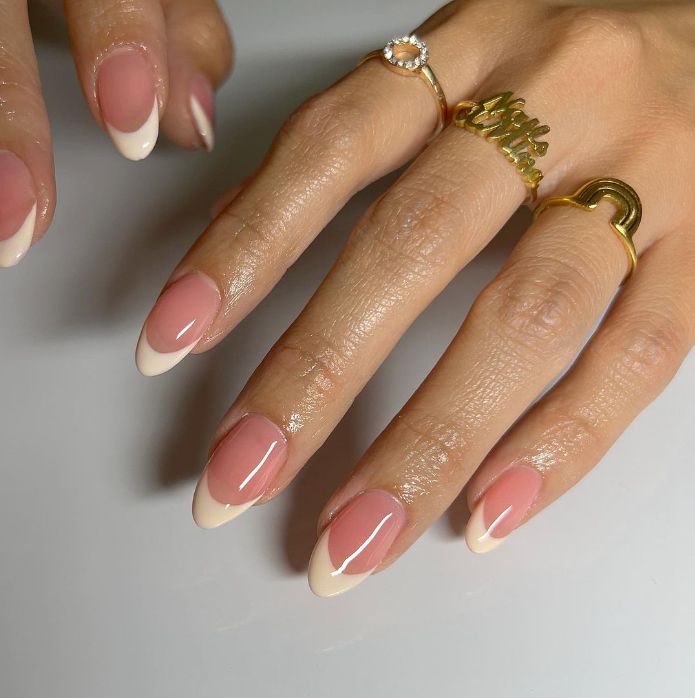 Timeless French Manicure: Chic Almond Nails with Glossy Nude Base and Classic White Tips