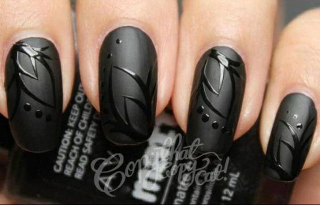 Sophisticated Black Matte Nails with Intricate Leaf Designs and Glossy Accents