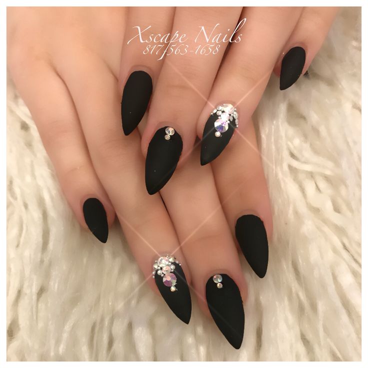 Bold and Sophisticated Matte Black Nail Design with Glamorous Rhinestone Embellishments.