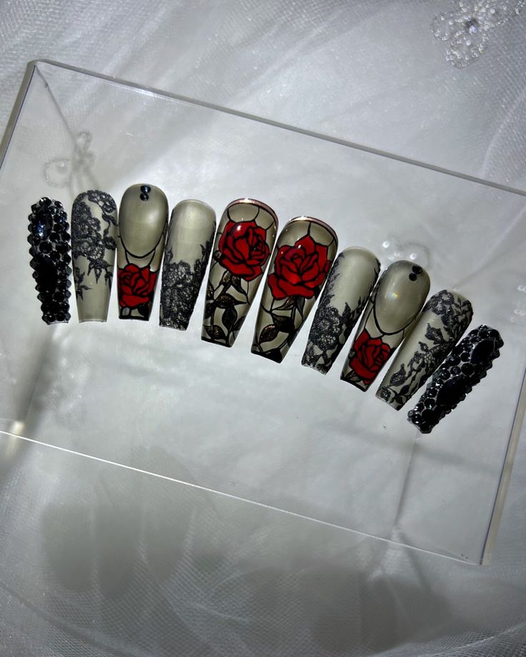 Sophisticated Nail Art: Intricate Black Lace Meets Bold Red Roses in Textured Finishes