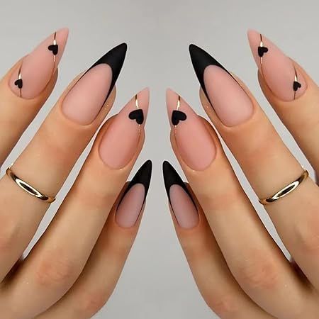 Elegant Stiletto Nail Art: Chic Heart Design in Soft Nude and Bold Black Tones.