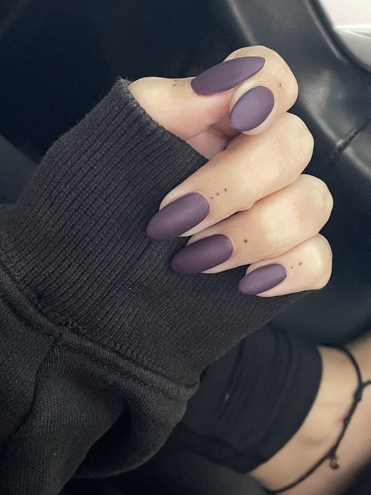 Sophisticated Matte Purple Nails: Chic Design Meets Comfort in Cozy Black Sweater.