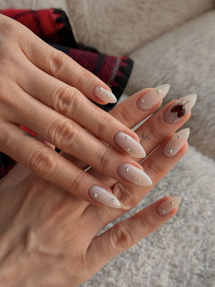 Sophisticated Almond-Shaped Nails: Soft Nude Base with Delicate Rhinestones for Versatile Elegance.