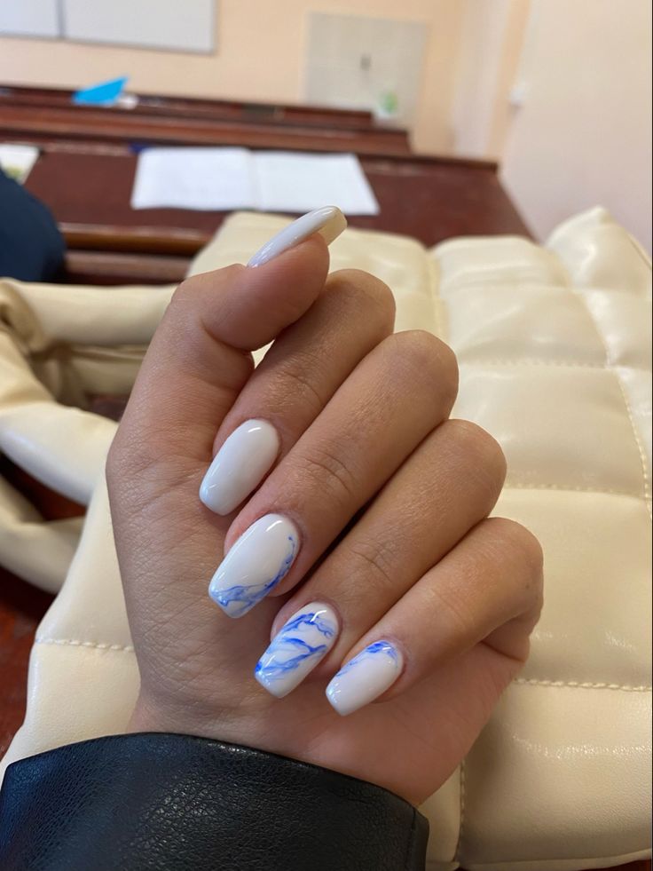 Chic White and Blue Swirl Nail Design with Elegant Marbled Tips