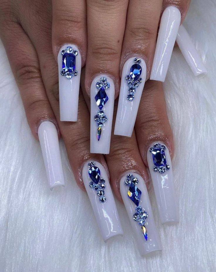 Elegant Glossy White Acrylic Nails Enhanced with Glamorous Blue Gemstone Decorations