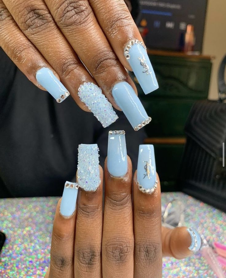 Elegant Soft Blue Nail Design with Glossy Polish and Textured Accents