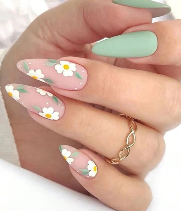 Charming Floral Nail Design: Delicate Daisies on Soft Pink with Matte Green Accents for a Playful Spring Aesthetic.