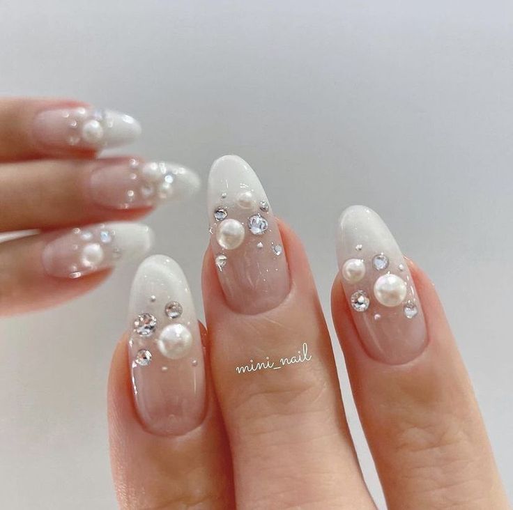 Sophisticated Ombre French Tip Nails Embellished with Pearls and Rhinestones.