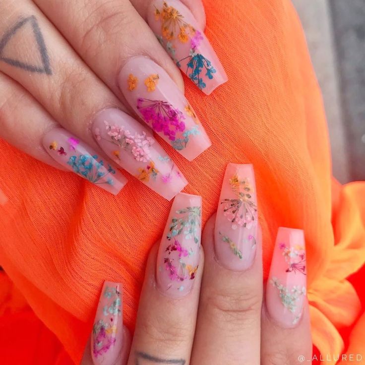 Vibrant Floral Nail Design: A Whimsical Blend of Pastel and Bold Colors on Transparent Backgrounds.