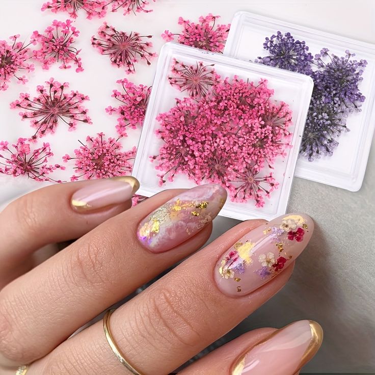 Delicate Floral Nail Design with Pastel Tones and Gold Accents for an Elegant, Textured Look.