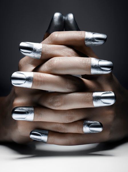 Sleek Silver Metallic Nail Design with Unique Half-Moon Accents for an Edgy Elegance.