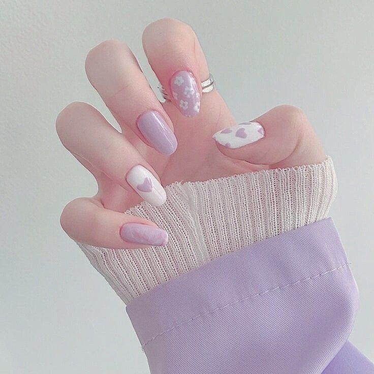 Whimsical Pastel Lavender Nail Design with Hearts and Floral Patterns.