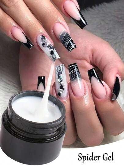 Sophisticated Black and Nude Nail Design with Artistic Spider Gel and Rhinestone Accents.