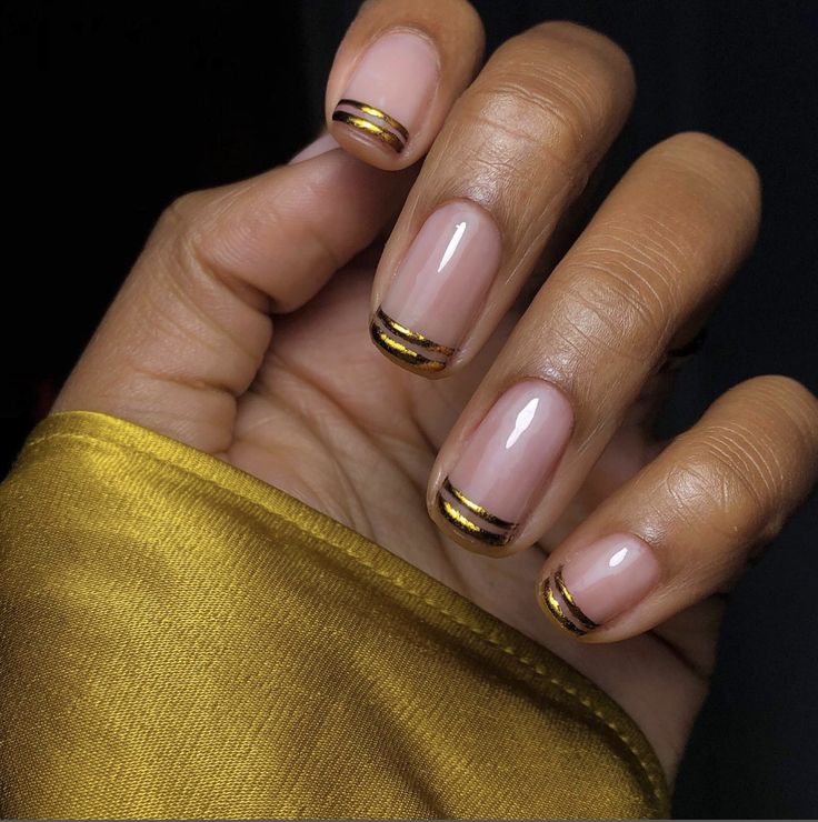 Elegant Nude Nails with Minimalist Gold and Black Stripes for Versatile Sophistication.