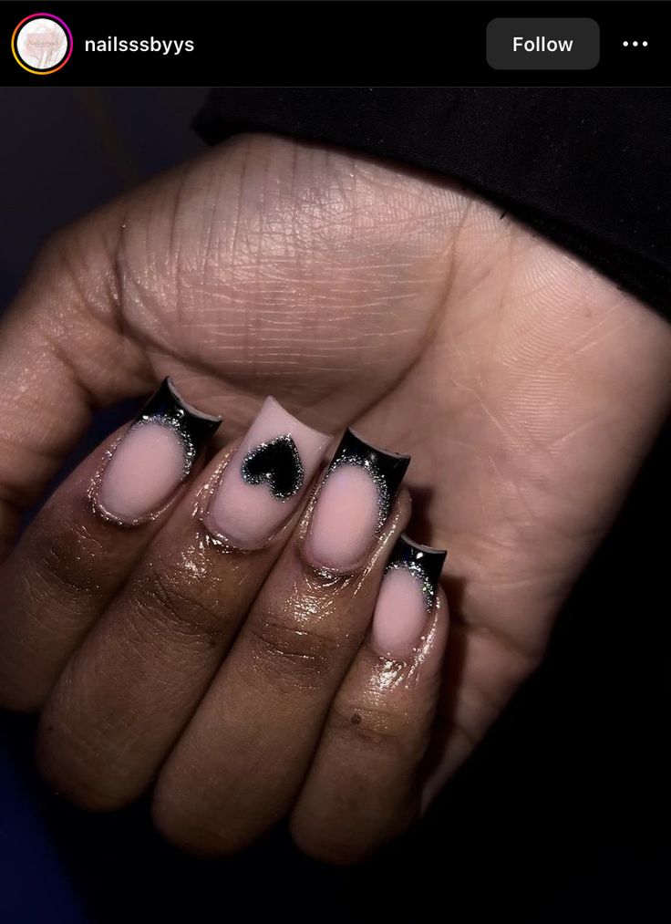 Chic Pink and Black Nail Design with Heart Accents and Glitter.